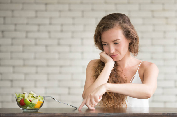 Beautiful young woman in joyful postures with salad bowl on the side - Φωτογραφία, εικόνα