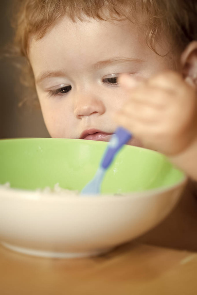 Portrait of cute male child eating - Photo, image