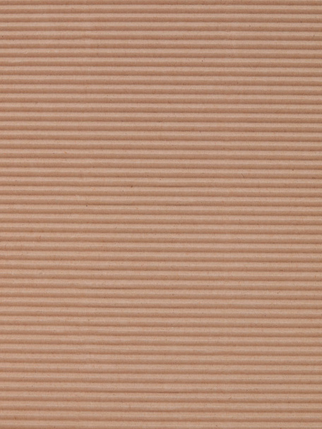 Brown corrugated cardboard paper useful as a background, soft pastel colour - Photo, Image