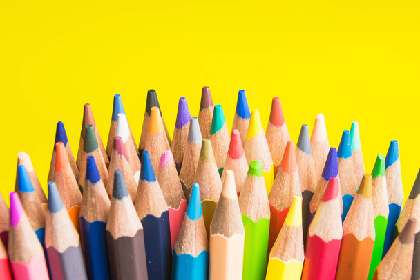 Back to school set multicolored pencils colorful making forms side view on a yellow backround - Foto, Imagem