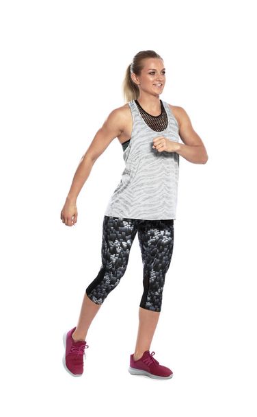Young female runner exercising on white background - Foto, afbeelding