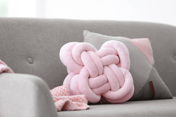 Pillows and plaid on sofa indoors. Unusual cushion design - Фото, зображення