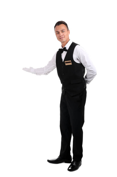 Full length portrait of young waiter in uniform on white background - Фото, зображення