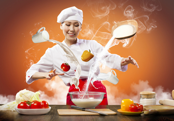 Asian female cooking with magic - Foto, imagen