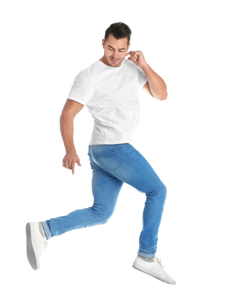 Young man in stylish jeans on white background - 写真・画像