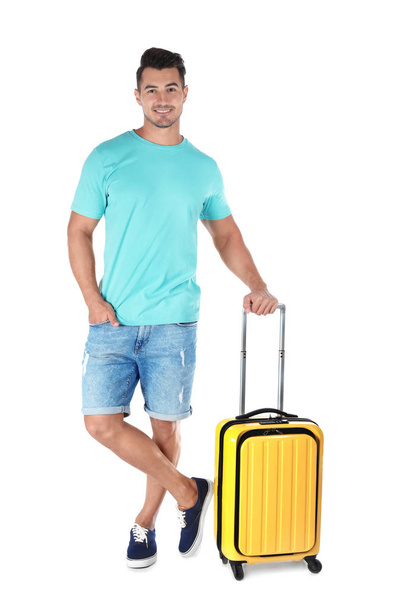 Young man with suitcase on white background - Valokuva, kuva