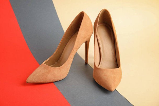 Pair of beautiful shoes on color background - Valokuva, kuva