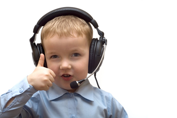 Boy in ear-phones shows gesture - 写真・画像