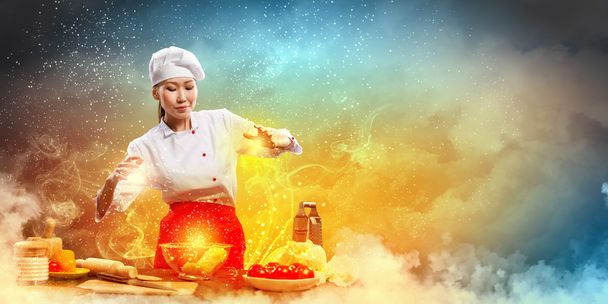 Asian female cooking with magic - Photo, image
