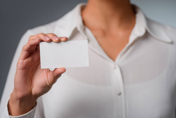 Woman holds a visit card. - Photo, image
