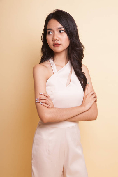 Portrait of beautiful young Asian woman  on beige background - Fotó, kép
