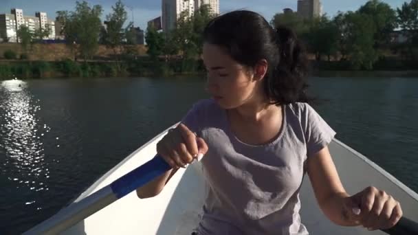 Sad young girl rowing in a boat - Filmati, video