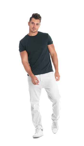 Young man in stylish jeans on white background - Valokuva, kuva