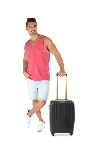 Young man with suitcase on white background - 写真・画像