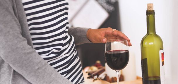 Young woman in the kitchen with glasses of a wine - Foto, Bild