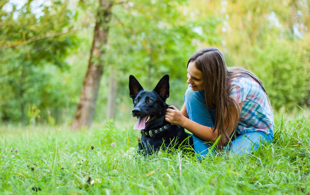 Portrait of young teenage girl with a shepherd dog in the park outdoor - Foto, afbeelding