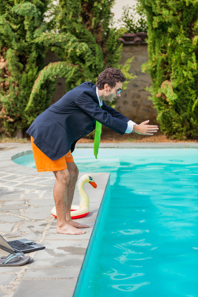 Funny Young Businessman with SwimmingTrunks Diving into the Poo - Zdjęcie, obraz