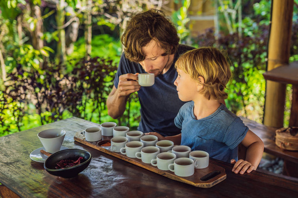 Dad and son tasting different kinds of coffee and tea on Bali island - Zdjęcie, obraz
