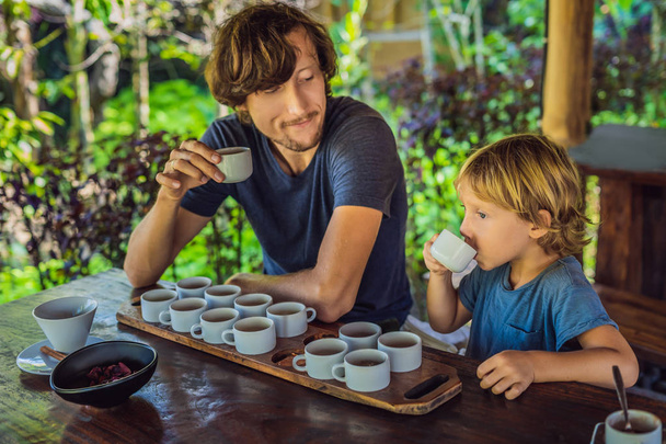 Dad and son tasting different kinds of coffee and tea on Bali island - Foto, Bild