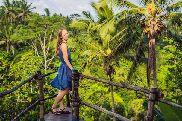 Young woman traveler posing at view point with jungles on background, Bali, Indonesia. - Foto, imagen