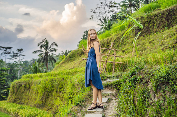 Young woman posing at Green cascade rice field plantation, Bali, Indonesia. - Фото, изображение