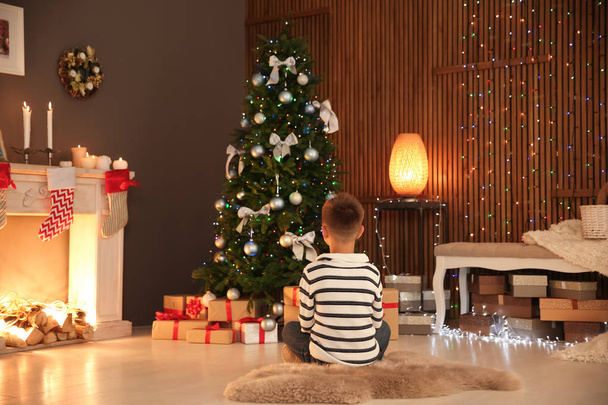 Little child decorating Christmas tree of foam plastic at home - Foto, imagen
