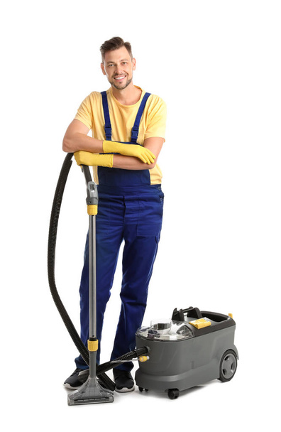 Male janitor with carpet cleaner on white background - Foto, Bild