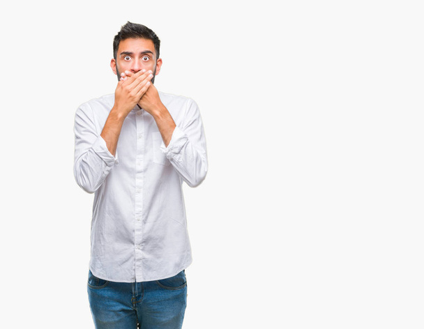 Adult hispanic man over isolated background shocked covering mouth with hands for mistake. Secret concept. - Fotoğraf, Görsel