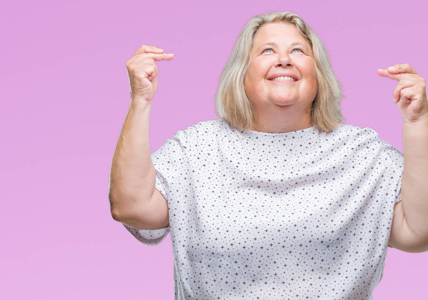 Senior plus size caucasian woman over isolated background smiling crossing fingers with hope and eyes closed. Luck and superstitious concept. - Photo, Image