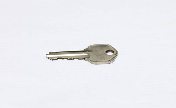 One metal flat key isolated on the white background - Photo, Image