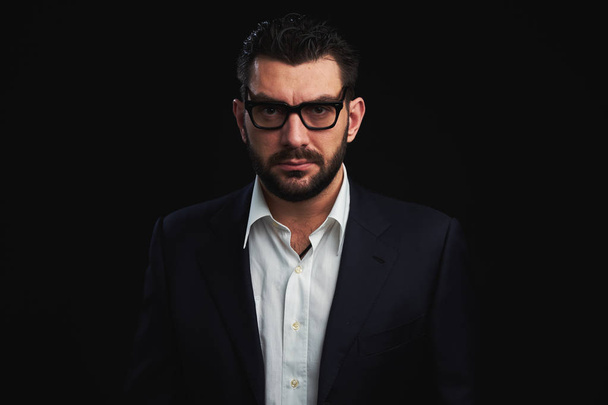 handsome bearded man in fashionable clothes and glasses over black background - Photo, Image