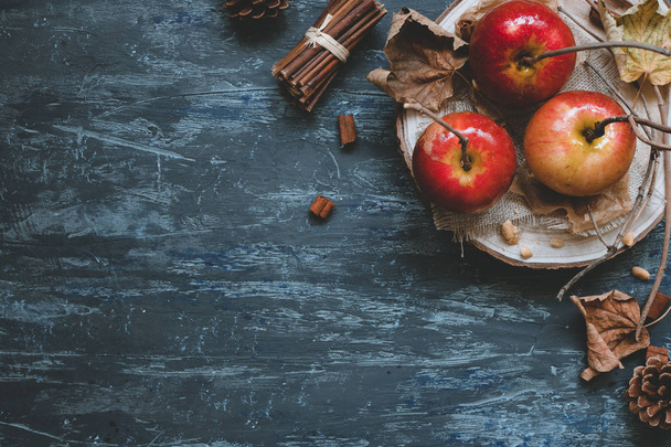 Autumn background with copy space. Delicious autumn caramel apples with autumn decoration, top view. - Fotó, kép