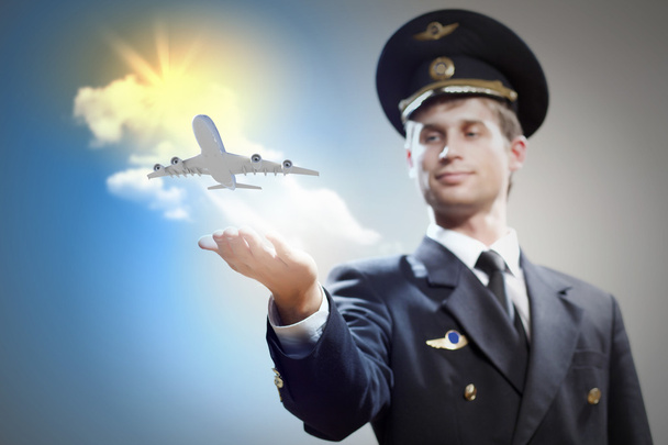 Image of pilot with plane in hand - Fotó, kép