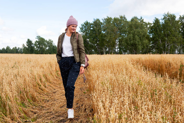 Foto de moda al aire libre de la joven hermosa mujer en el campo de oro en otoño cálido invierno. Abrigo de otoño acogedor
 - Foto, Imagen