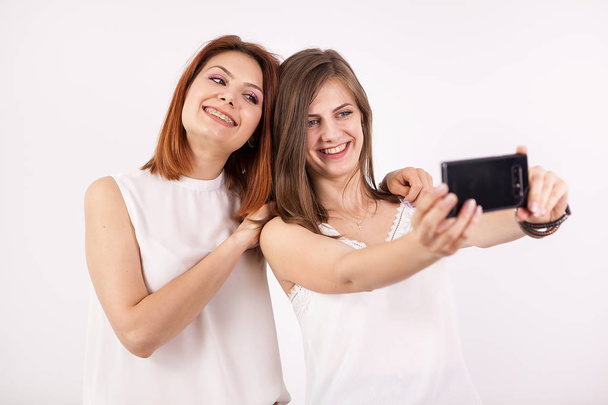 Two happy girls taking a selfie - Photo, Image