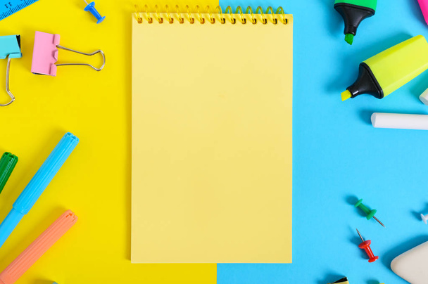 School accessories on a yellow-blue bright background. Back to school concept. Office and student supplies. Free space for your project. The top view. Flat lay. - Foto, imagen