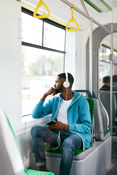 Man Riding In Bus Listening Music In Headphones - Foto, afbeelding