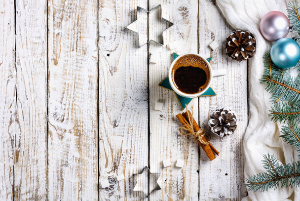 Cup of hot coffee with sugar and cinnamon on old wooden table with spruce branches. Top view flat lay group objects - Фото, зображення