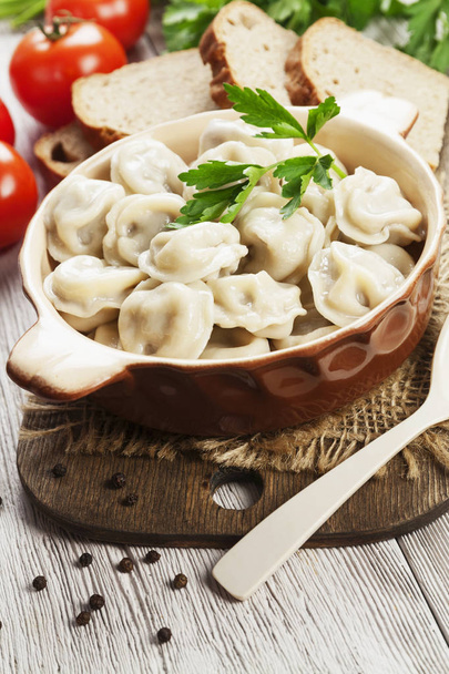 Delicious dumplings in the pot on the table - Photo, Image