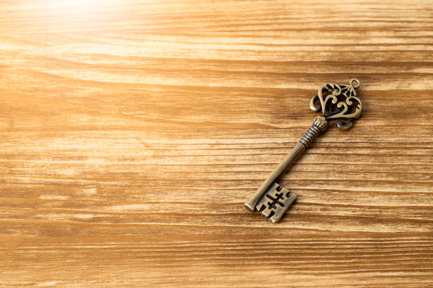 Vintage key on wooden background - 写真・画像