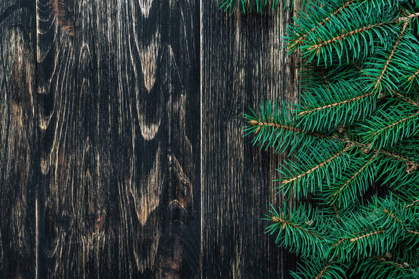 Spruce branches on a dark vintage wooden background. Christmas concept - Foto, immagini