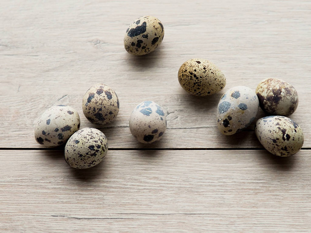 quail eggs in wooden plate over dark old wooden background. - Fotografie, Obrázek