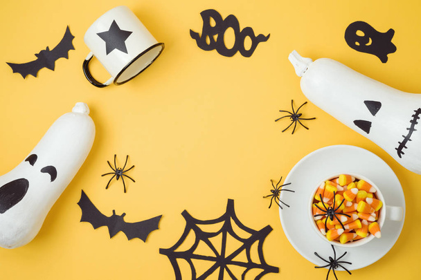 Halloween holiday background with jack o lantern pumpkins, candy corn and decorations. - Photo, image