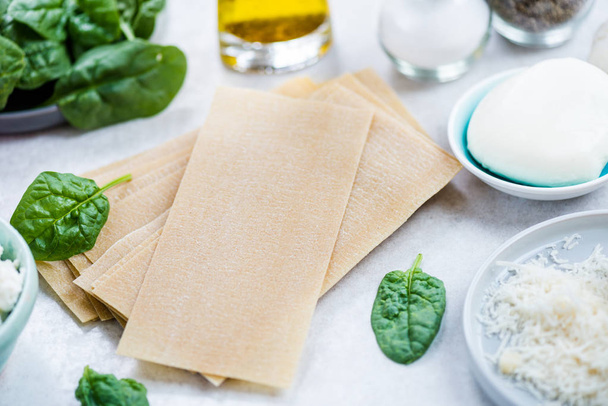 Ingredients for Vegetarian Spinach and Ricotta Lasagna, grey background  - Photo, image