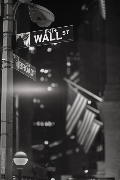 Broadway and Wall Street Signs at the night with US flags on background, Manhattan, New York - Foto, Bild