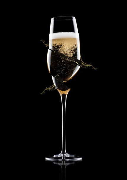 Elegant broken glass of yellow champagne with bubbles on black background with reflection - Фото, изображение
