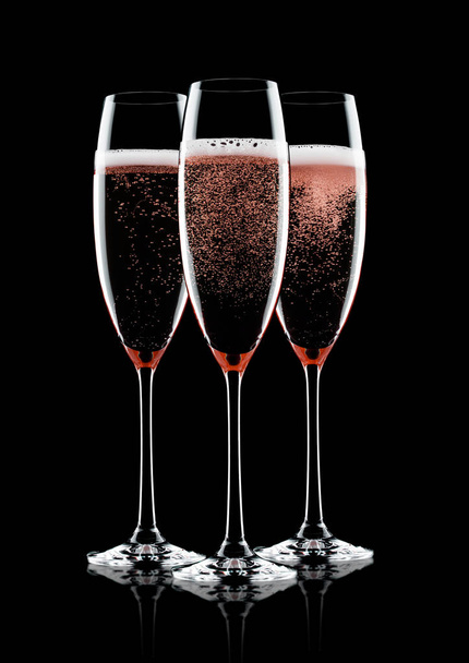 Rose pink champagne glasses with bubbles on black background with reflection - Photo, Image