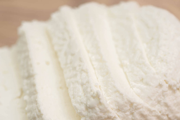 sliced  white cottage cheese on wooden cutting board  macron - Фото, зображення