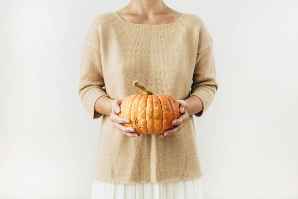 Young pretty woman holding halloween pumpkin on white background. Fall autumn concept. - Photo, Image