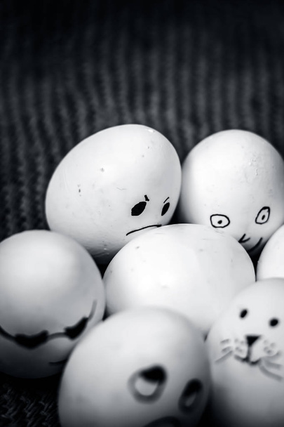 Close up view of eggs with funny faces drawn on them. - Fotografie, Obrázek